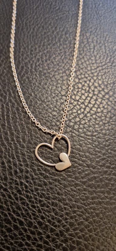 Kalevala silver necklace with open and filled heart pendants