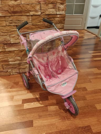 Baby Born twin doll stroller with some wear and a slightly crooked front wheel