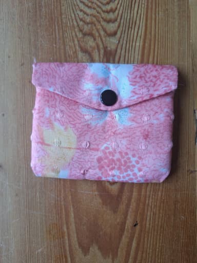 Small pink patterned jewelry pouch with snap closure