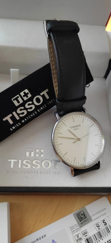 Tissot unisex wristwatch with white dial and black leather strap