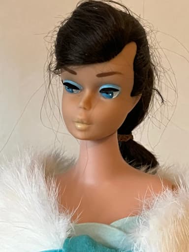 Vintage dark-haired Barbie doll with swirl ponytail