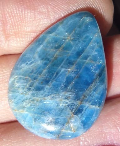 Apatite cabochon gemstone with color play for chakra healing