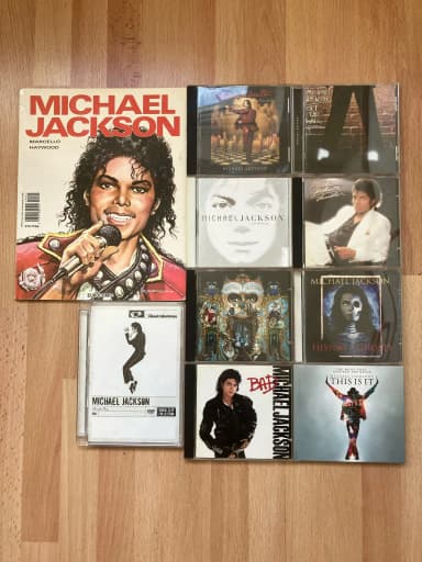 Michael Jackson collection with 8 CDs, 1 DVD, and 1 comic book