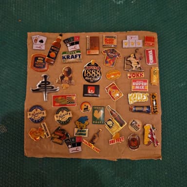 Collection of 32 pins including Sofiero, Kalles Kaviar and more