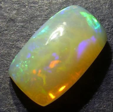 Ethiopian opal cabochon gemstone with vibrant color play and chakra pattern