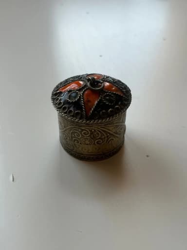 Vintage embossed metal box with enamel details