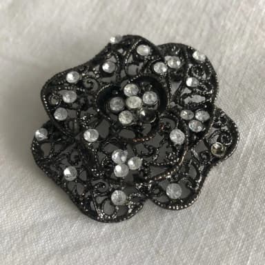 Silver metal brooch with stones