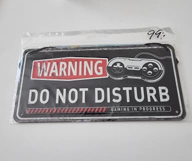 Metal sign with 'Gaming in progress' text