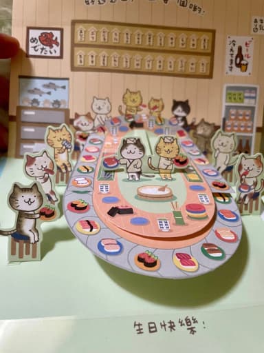 Pop-up-Karte mit Katzen in einem Sushi-Restaurant