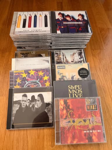 Large collection of CDs featuring U2, Oasis and Simple Minds