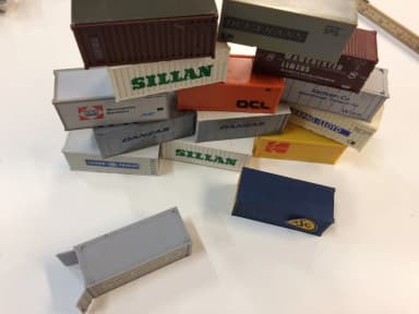 Various shipping containers including ASG model in H0 scale