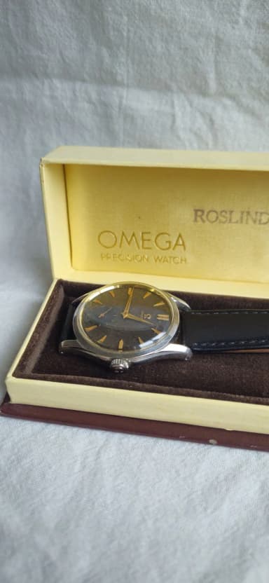Vintage Omega wristwatch with dark patinated dial
